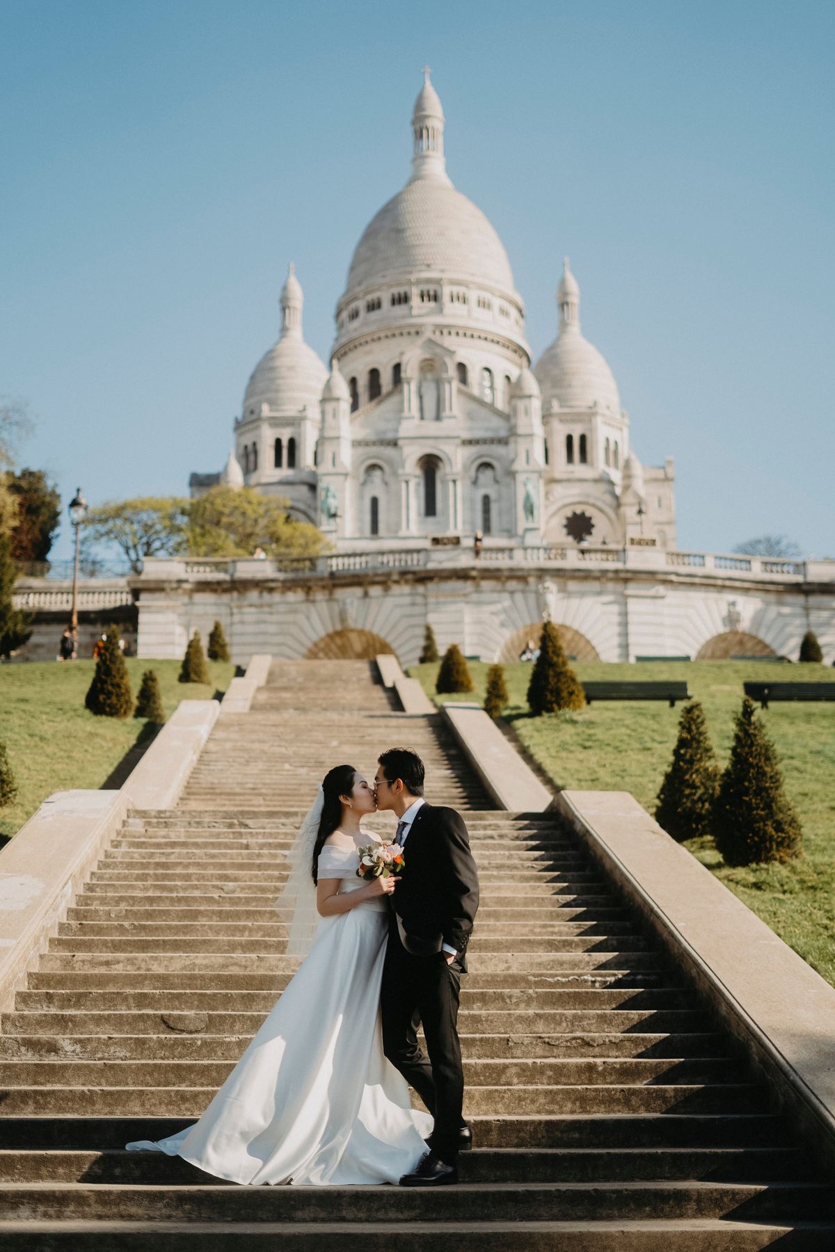 Bride and groom posing near Sacré-Cœur during a Paris elopement photoshoot