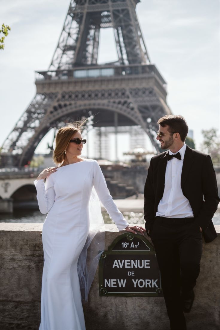 Bride and groom walking in Paris with the Eiffel Tower in the background