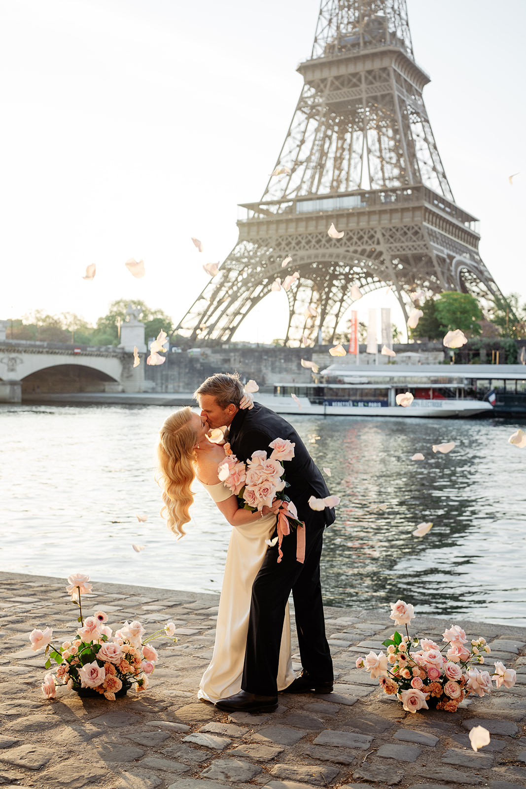 Bride and groom by the Seine with the Eiffel Tower during a Paris elopement