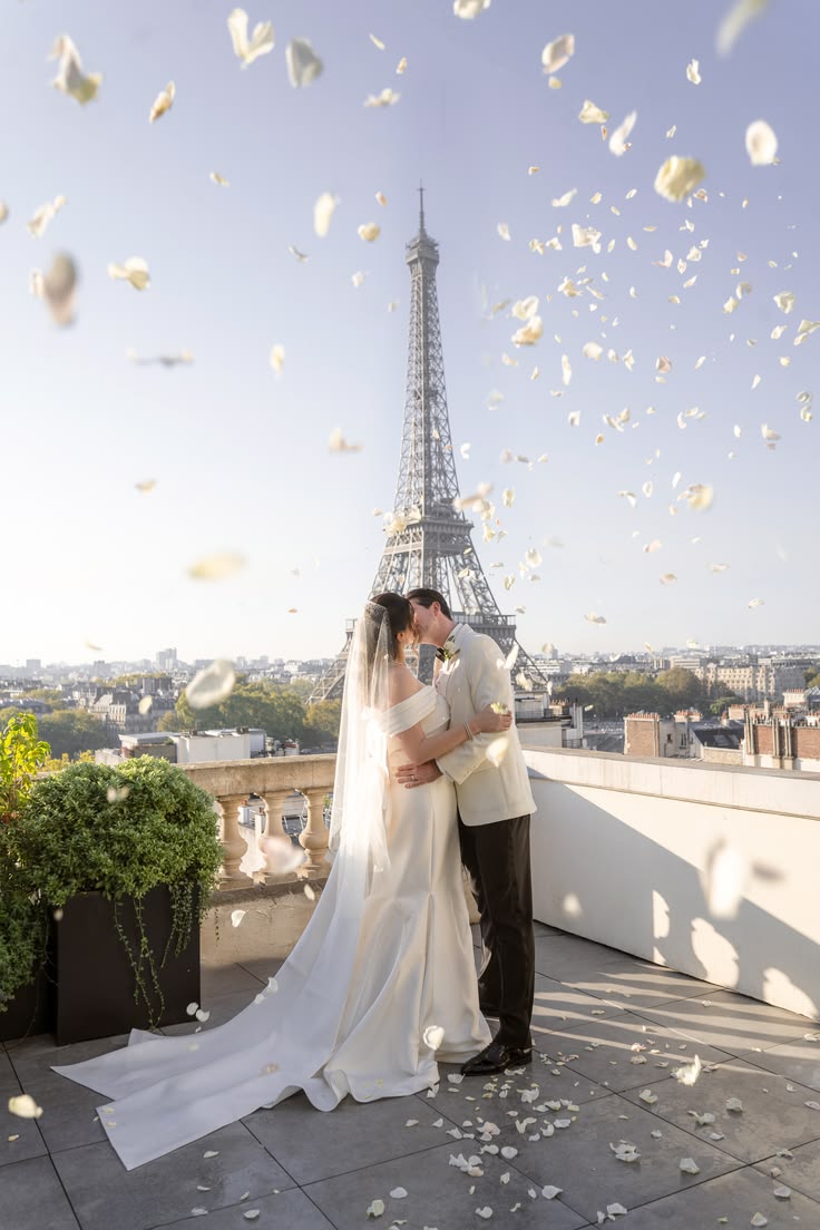 Bride and groom celebrating their Paris elopement with the Eiffel Tower in the background
