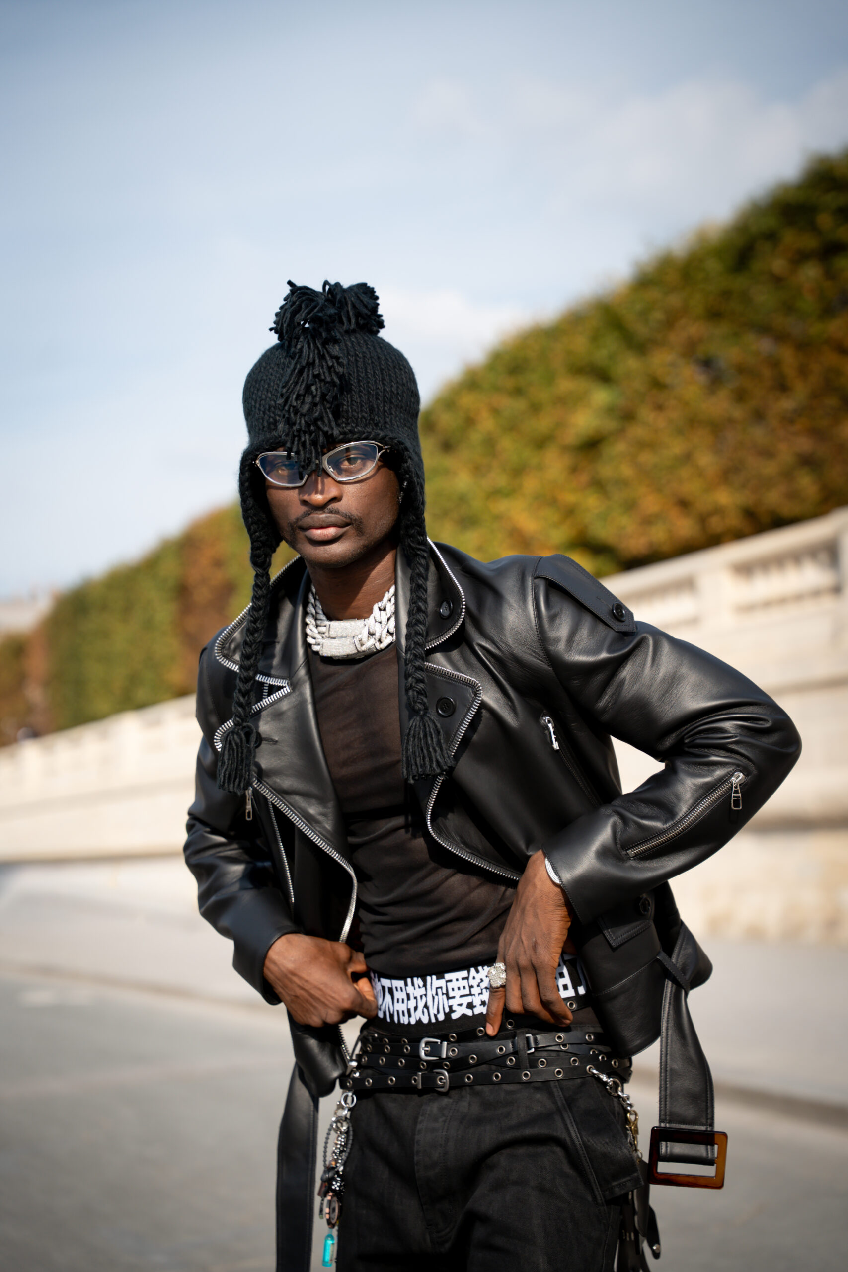 Client posing in a black fashion look during Paris Fashion Week