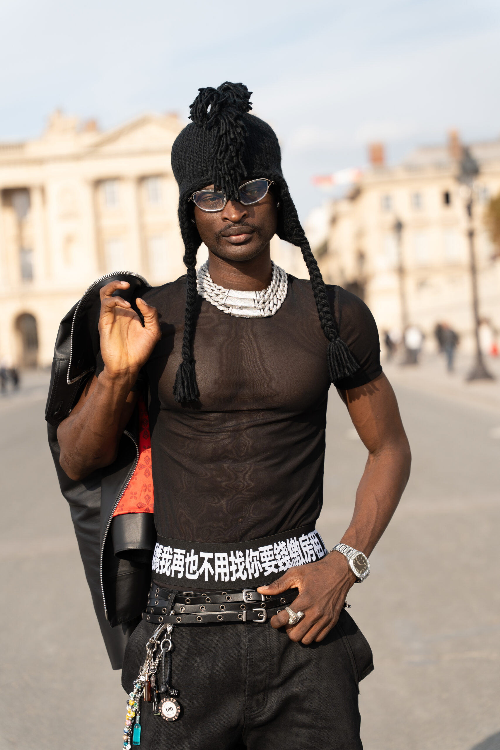 Client posing in a black fashion look during Paris Fashion Week