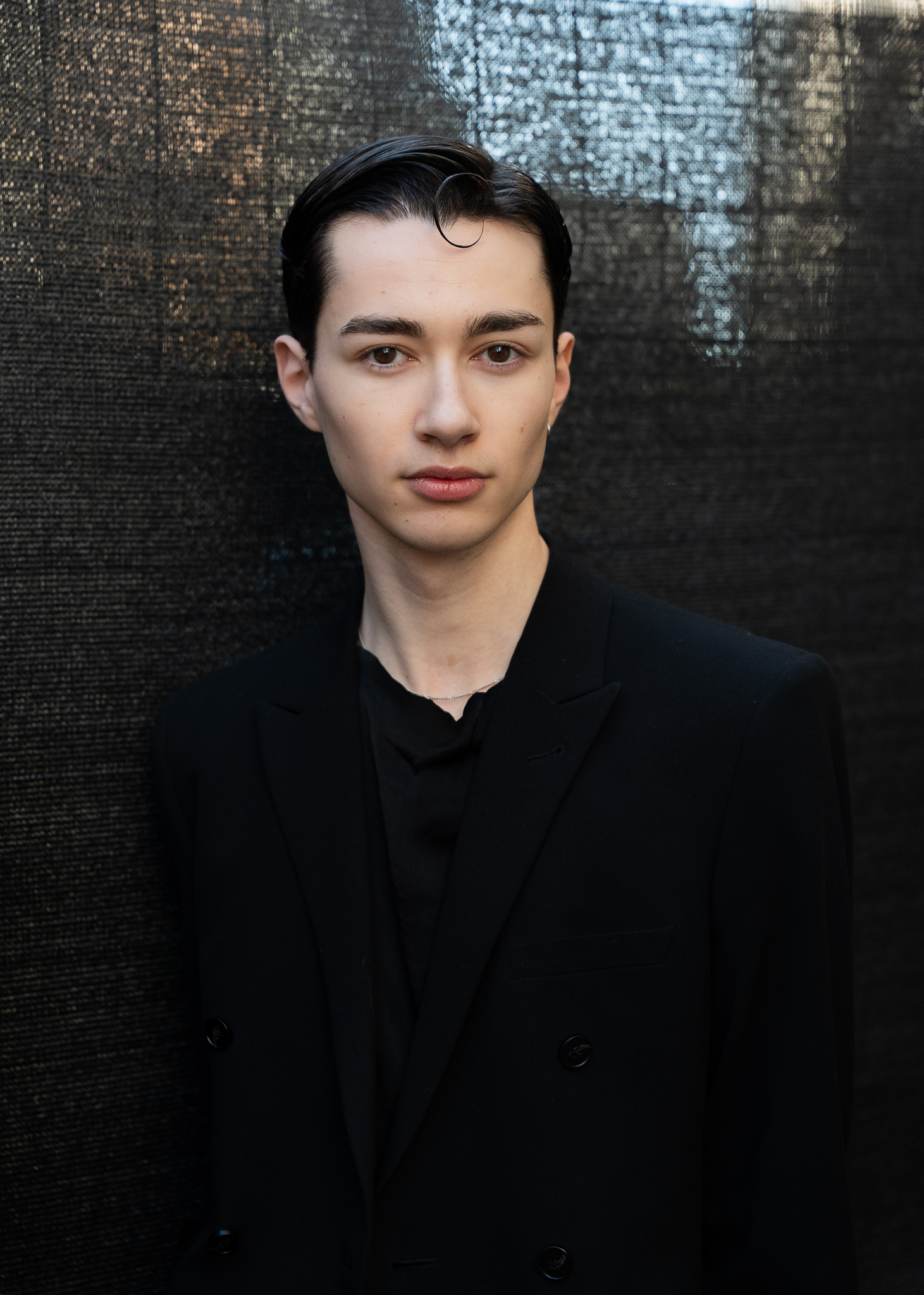 Minimal fashion portrait of a client in black during Paris Fashion Week