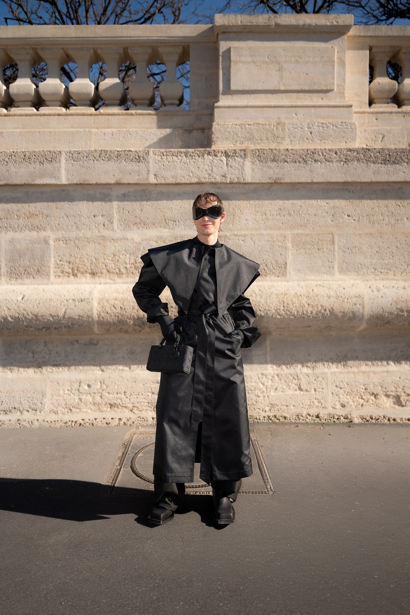 Full-body portrait of a client wearing black during Paris Fashion Week