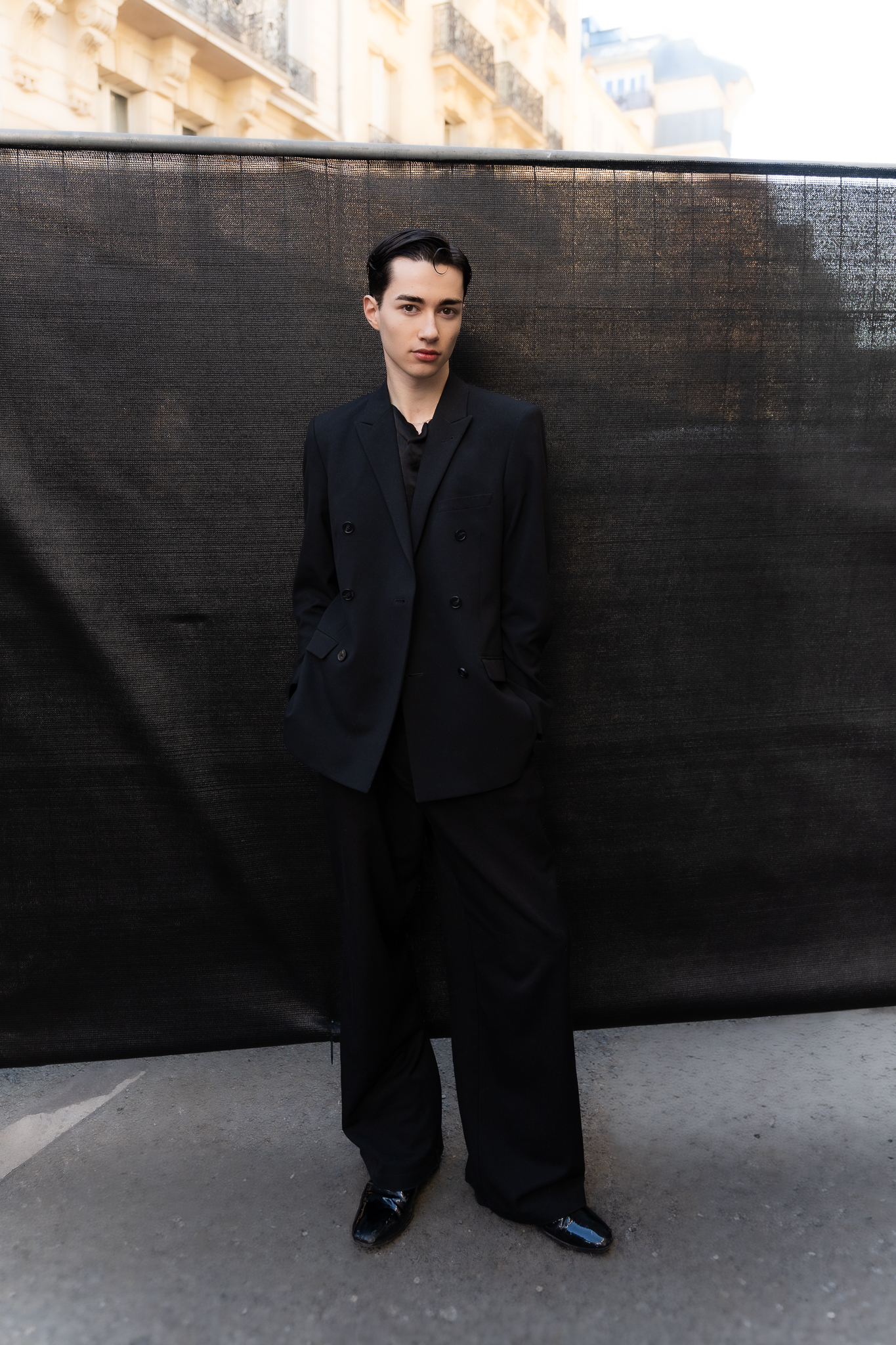 Full-body editorial fashion portrait in black outfit during Paris Fashion Week