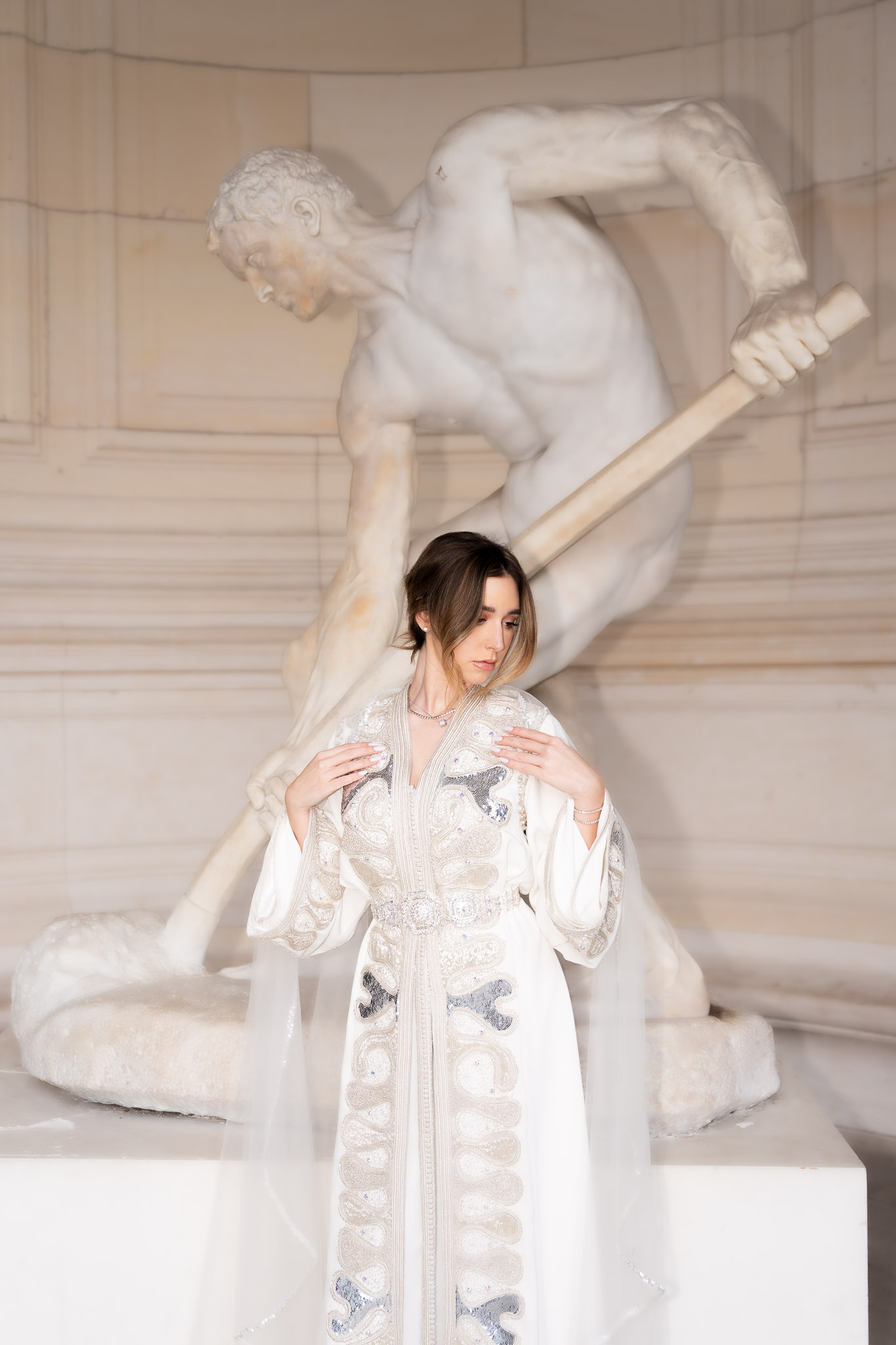Editorial portrait of a woman adjusting her embroidered caftan near Palais de Tokyo in Paris