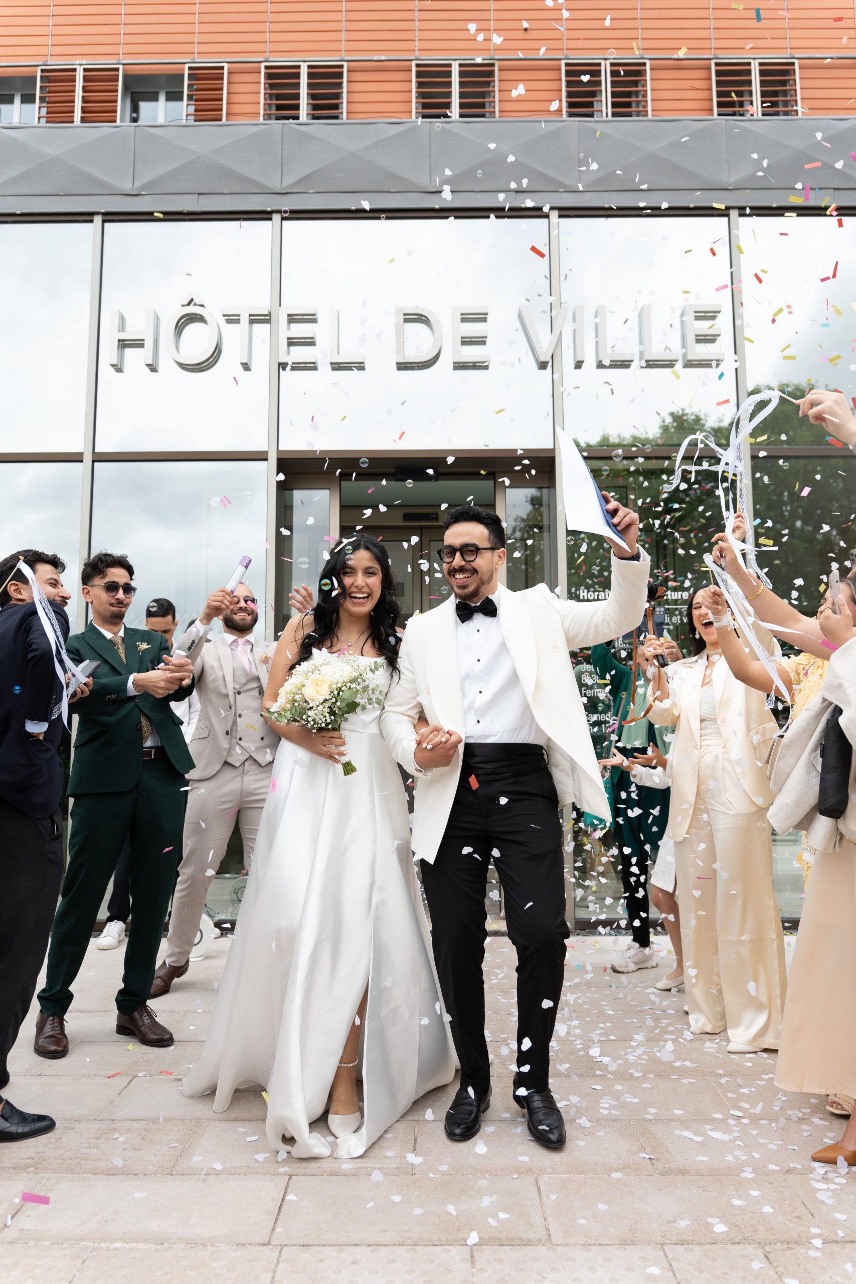 Bride and groom leaving L’Haÿ-les-Roses City Hall under confetti