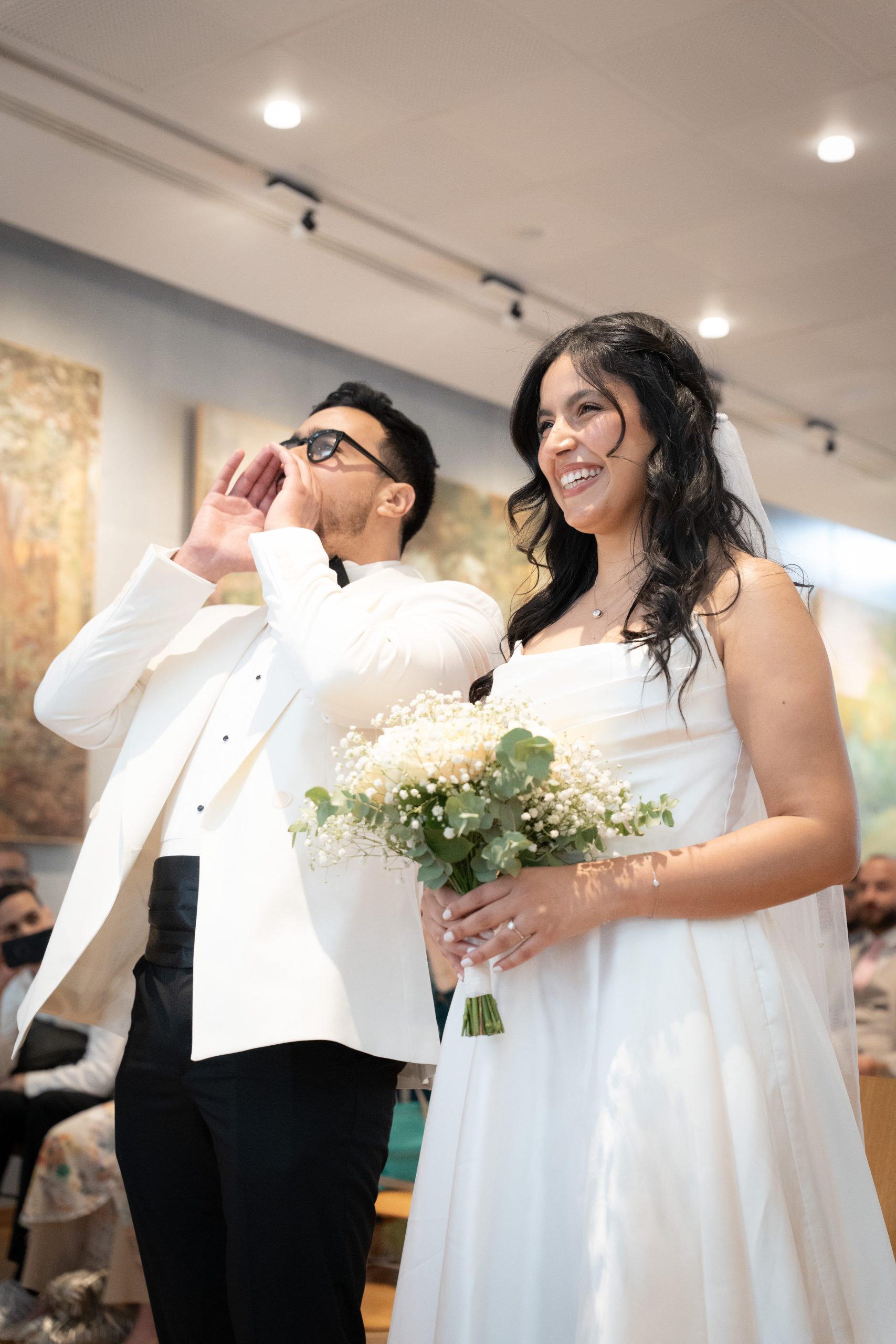 Bride and groom laughing inside the city hall during their civil wedding in Île-de-France