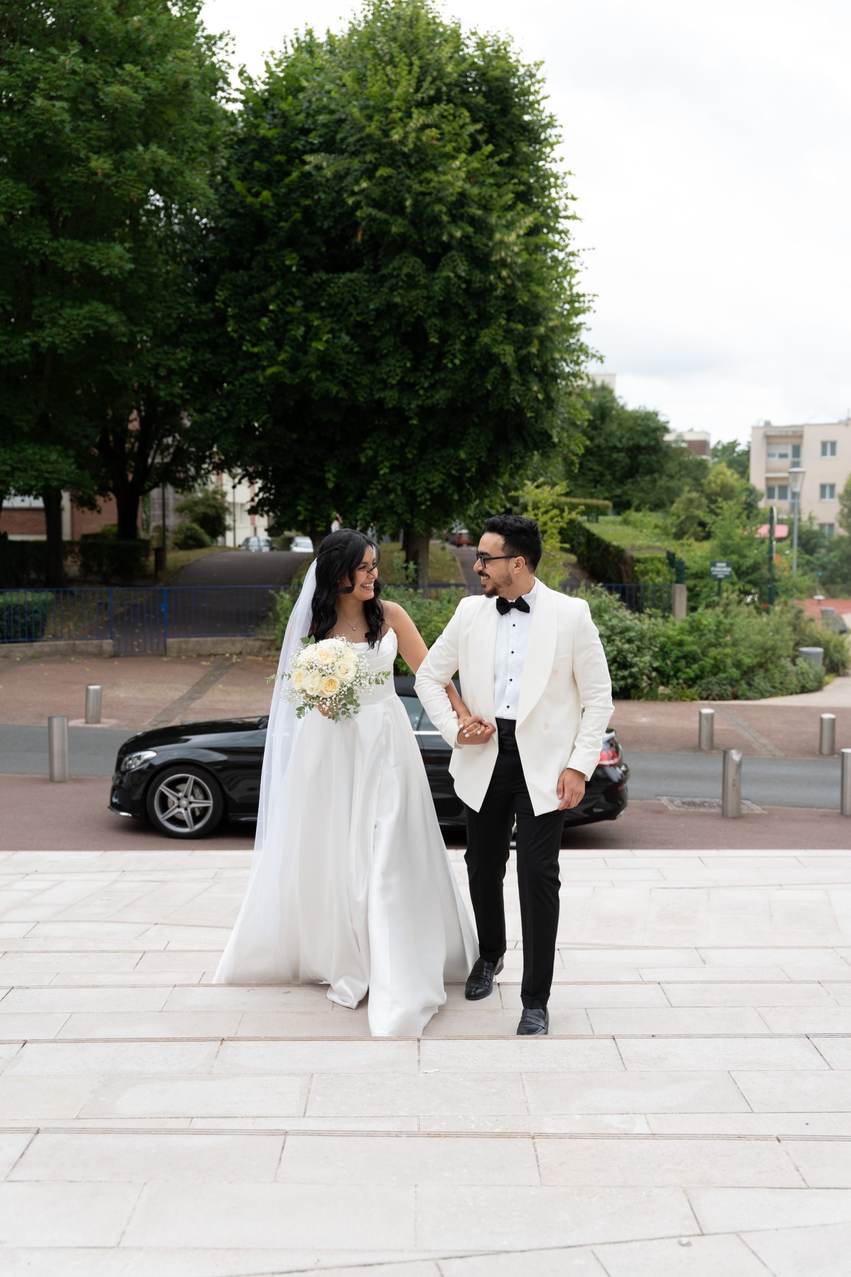 Bride and groom walking outside after their civil wedding at L’Haÿ-les-Roses City Hall