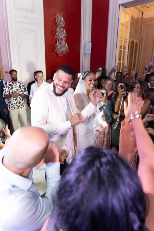 Groom celebrating with guests on the dance floor during a luxury wedding