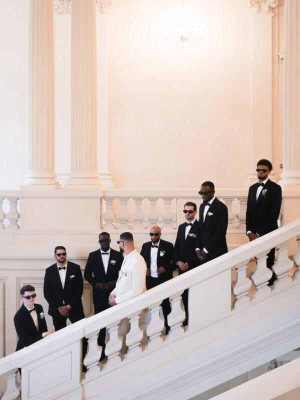 Groom party posing on the staircase at Château de Saint-Martin-du-Tertre