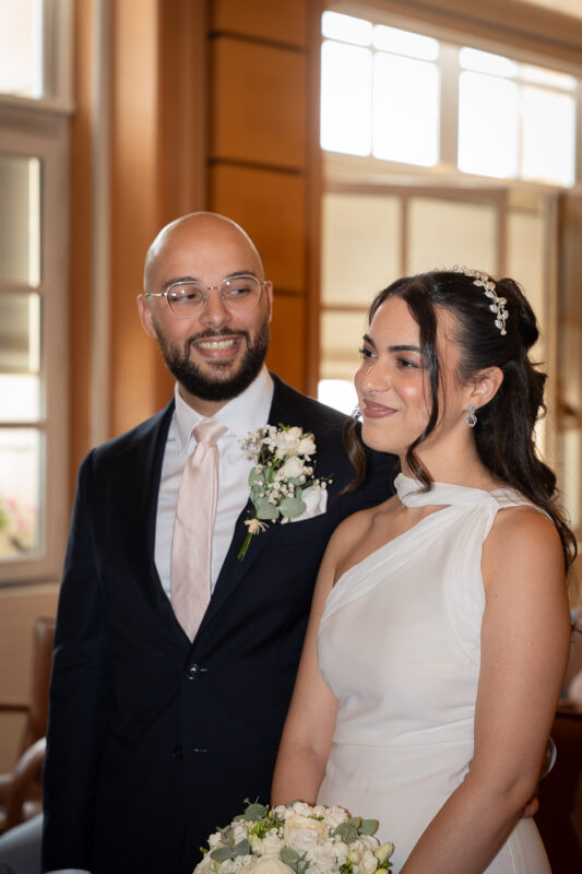 Newlyweds standing together in the ceremony room at Suresnes City Hall
