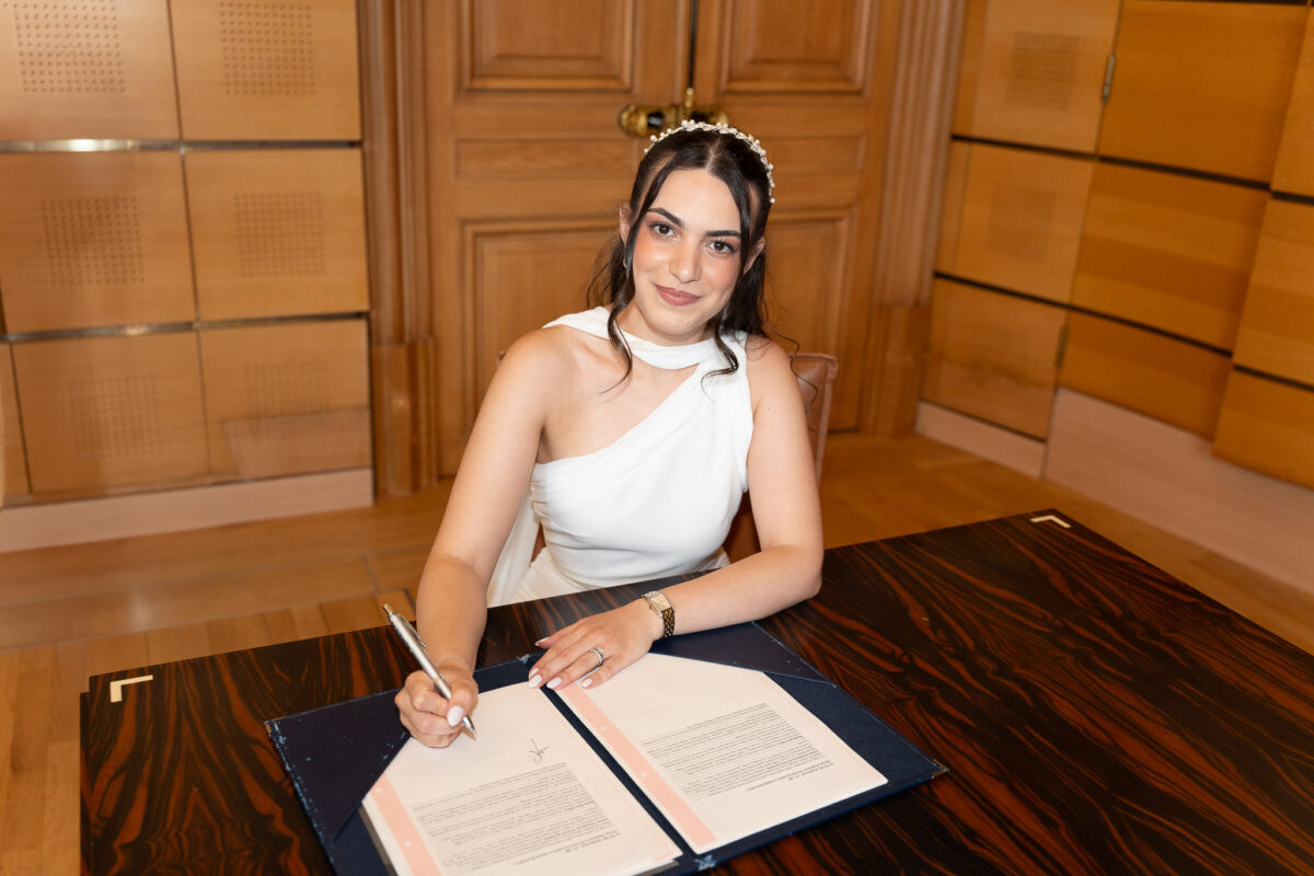 Bride signing the marriage register during a civil wedding in Suresnes