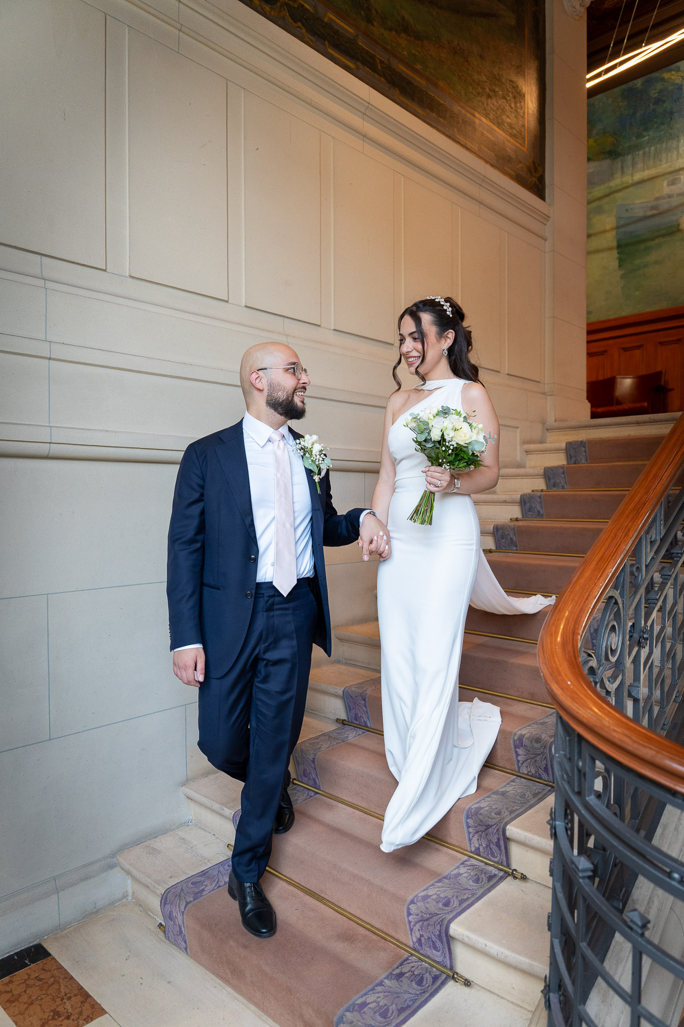 Bride and groom on the staircase inside Suresnes City Hall