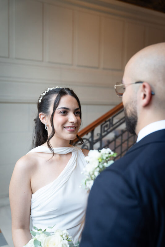 Bride smiling at the groom inside Suresnes City Hall after the ceremony