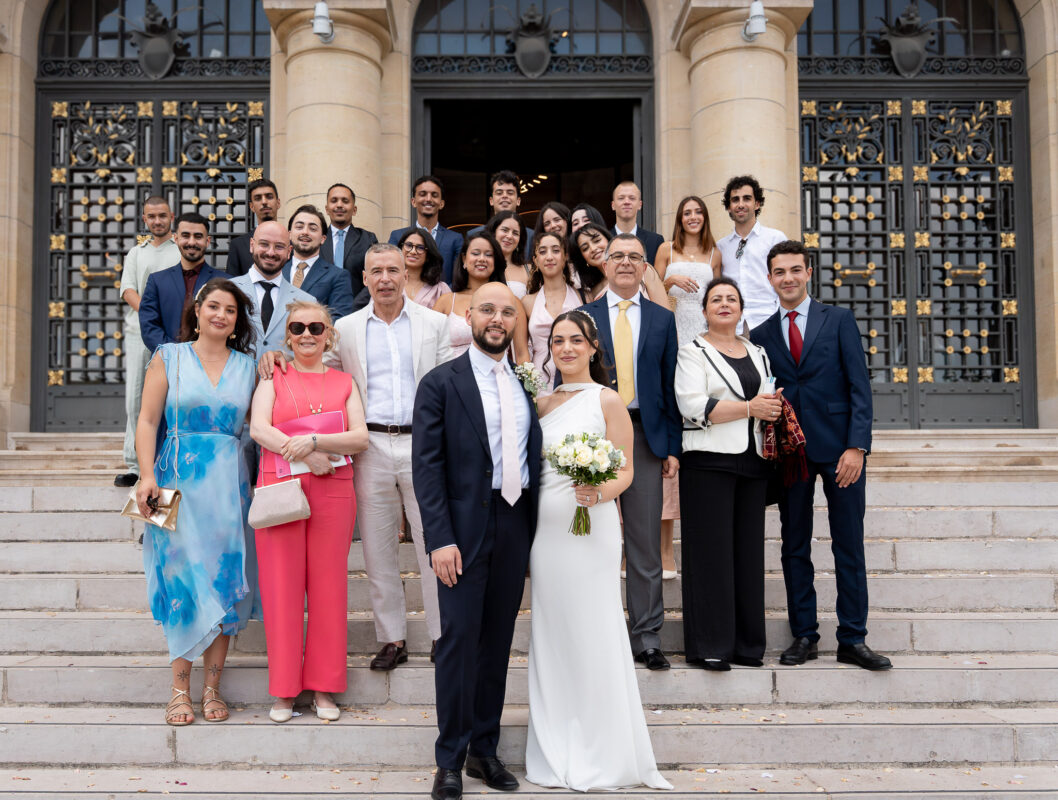 Group portrait of wedding guests outside Suresnes City Hall