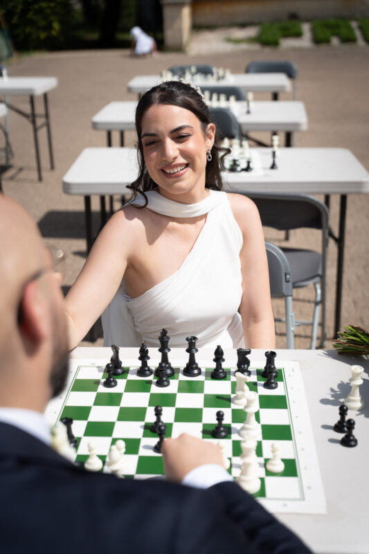 Bride smiling near a chessboard after her civil wedding in Suresnes