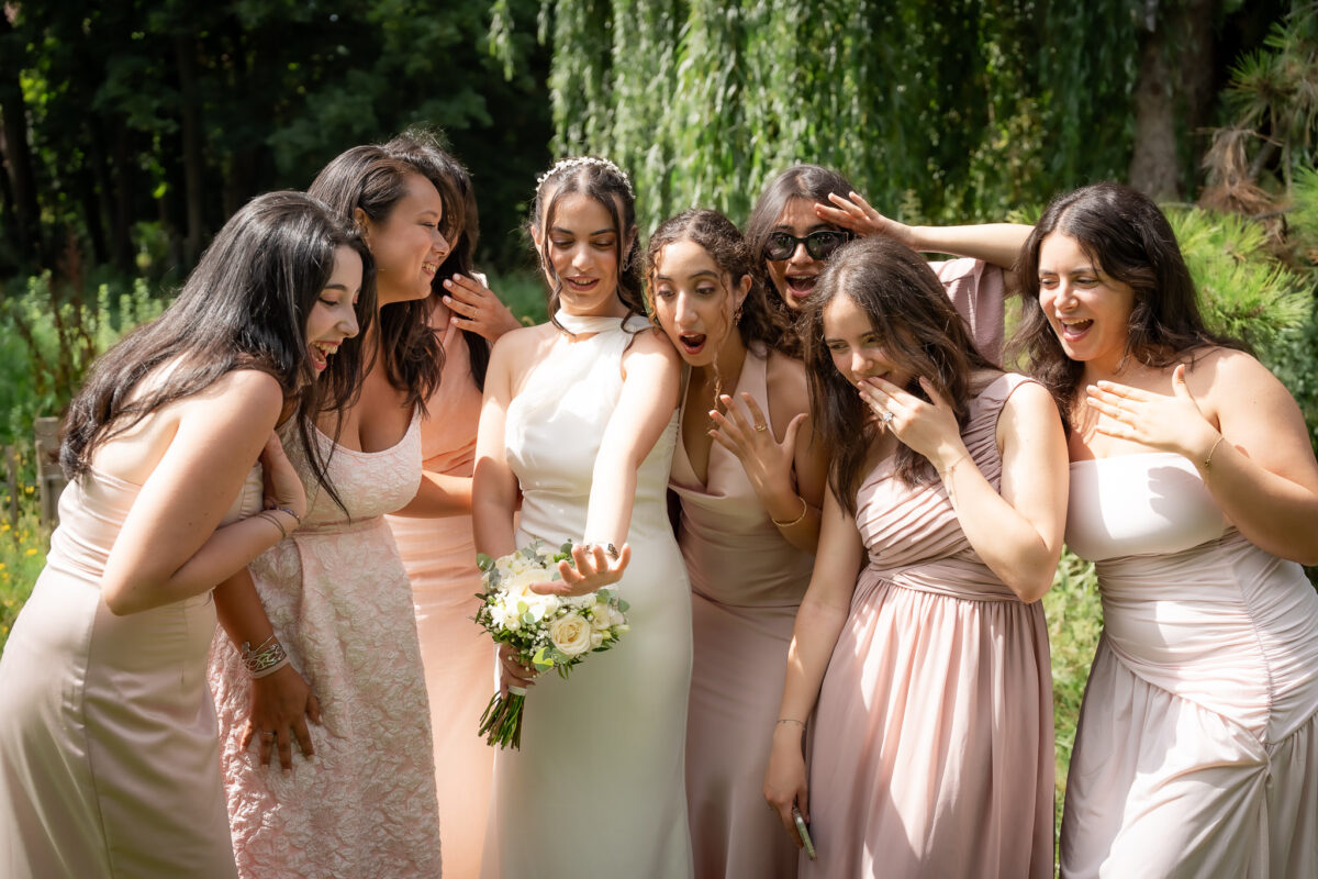 Bride surrounded by bridesmaids during a wedding portrait session in Suresnes