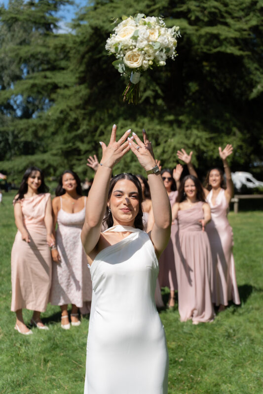 Bride standing with bridesmaids in a garden after a civil wedding in Suresnes