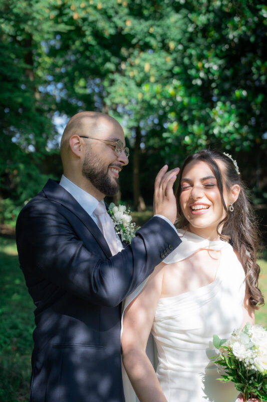 Groom gently touching the bride’s face during a wedding portrait session in Suresnes