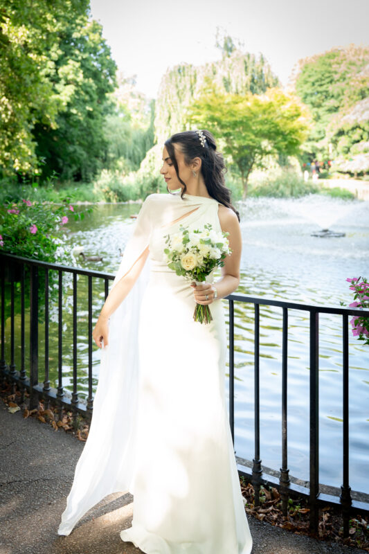Bride holding her bouquet by the river after her civil wedding in Suresnes