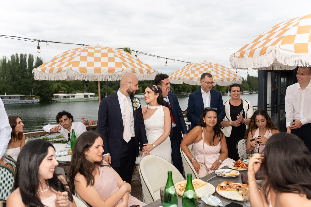 Wedding guests gathered for an outdoor lunch by the river in Île-de-France