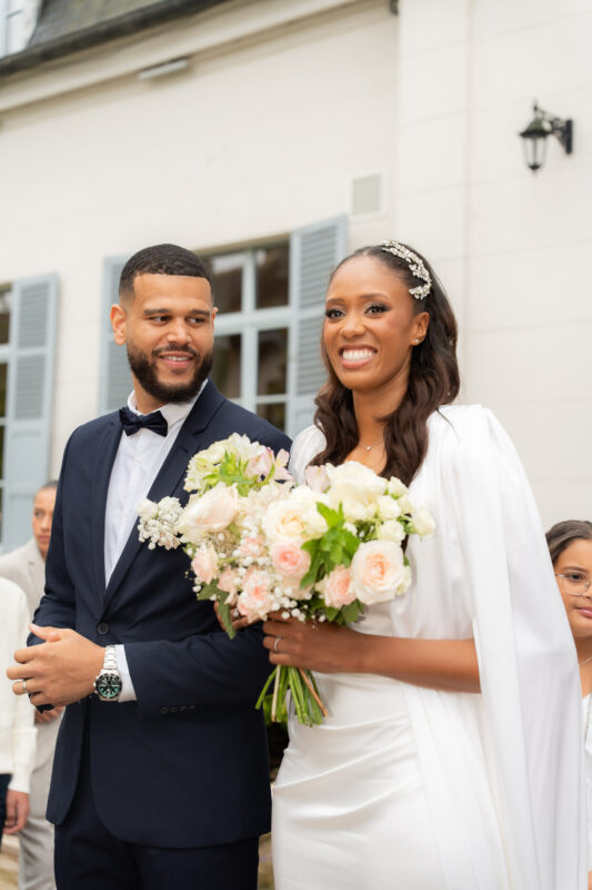 Bride and groom smiling during their wedding ceremony at Château de Saint-Martin-du-Tertre
