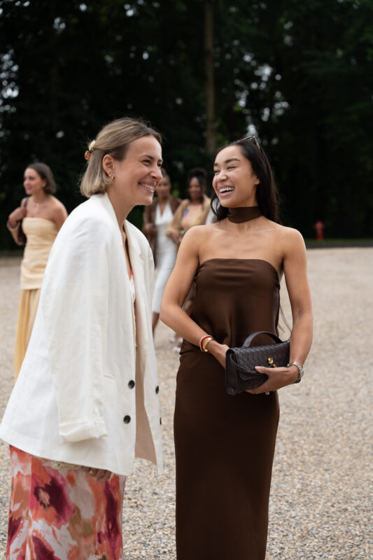 Wedding guests talking outdoors during a luxury château wedding near Paris